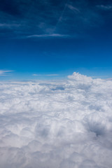 blue sky full of clouds seen from the plane in summer