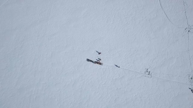 Finland's and Sweden's beautiful Tornio river at winter. Snowmobiles passing by and people ice fishing.