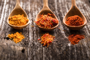 Various spices on wooden spoons. Food ingredients