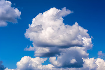 Idyllic blue sky with fluffy and thunderstorm clouds
