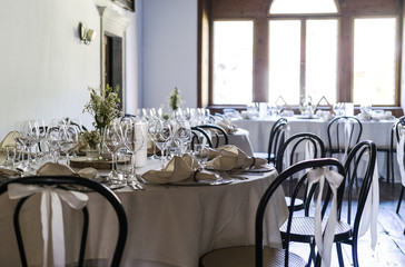 Decorated table on a wedding with wine glasses and blurred out background