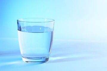 Glass of water in blue