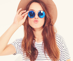 Portrait of young stylish laughing girl model in casual summer clothes in brown hat isolated on white background
