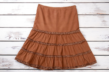 Retro women skirt. White beige wooden desks surface background.