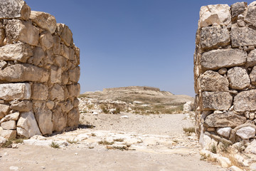 the ancient Israelite Fortress viewed through the Canaanite City wall gate at tel arad in israel