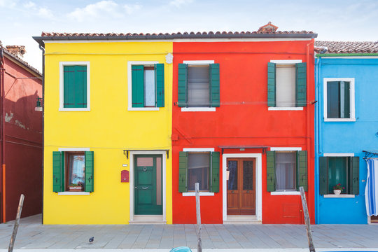 Rectilinear view of the colored facades of buildings on the island of Burano, near Venice, Italy © LALSSTOCK