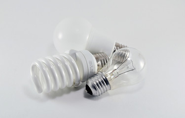 Three different types of light bulbs of different shapes on white background