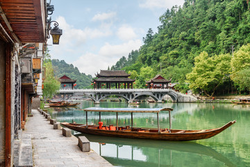 Parked wooden tourist boat on the Tuojiang River, Fenghuang - obrazy, fototapety, plakaty