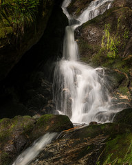 Waterfall, cascade between big rocks in ravine Ysperklamm