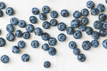 Fresh ripe blueberries over white. Food background. The concept of healthy eating and lifestyle.