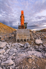 Excavator of great size extracting stone in an open-air mine