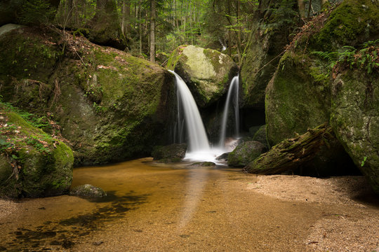 Waterfall, cascade between big rocks in ravine Ysperklamm