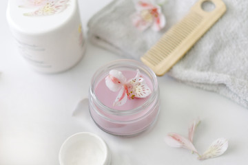 Fototapeta na wymiar Glass jar with light-pink hair cream