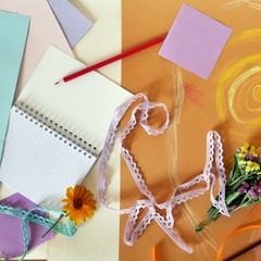 Decorative composition of hand-crafted items on yellow toned paper pasted with pastel, gift...
