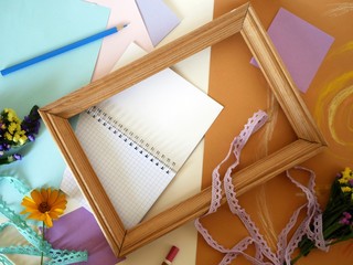 Decorative composition of hand-crafted items on yellow toned paper pasted with pastel, gift...