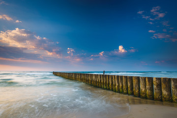 Sunset on the beach with breakwater, long time exposure