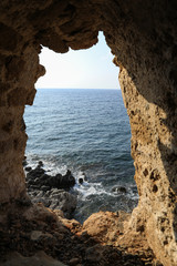 Beautiful seascape view through loophole of Monemvasia medieval castle overlooking the Aegean sea. Monemvasia, Peloponnese, Greece, June 2018.