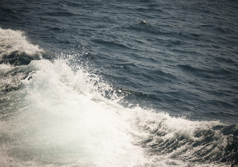 White crest of a sea wave. Selective focus. Shallow depth of field. Toned