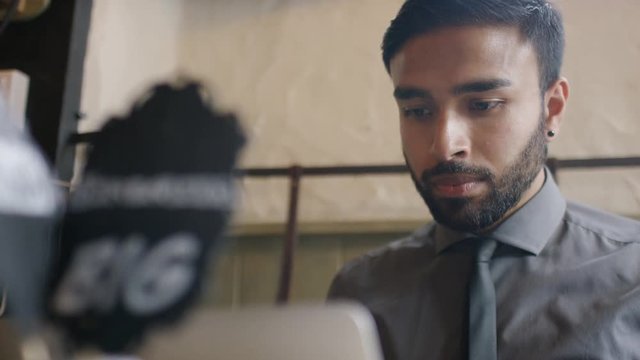 Milk in a coffee shop being heated by a barista, in slow motion