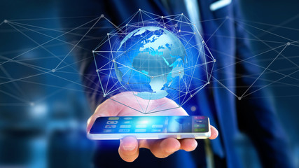Businessman using smartphone with a Connected network over a earth globe concept on a futuristic interface - 3d rendering