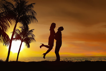 Silhouette of romantic couple in love with sunset view