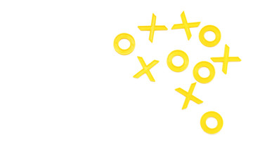 Yellow plastic figures for playing tic-tac-toe on a white background. Flat lay, top view