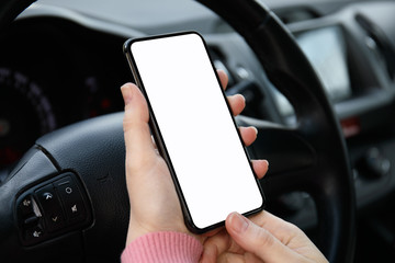 women hands holding phone with isolated screen in the car