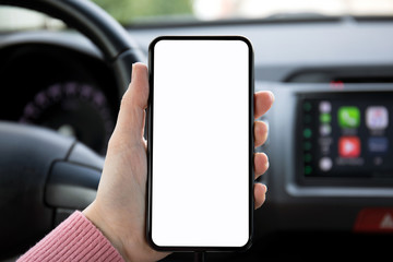 women hand holding phone with isolated screen in the car