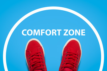 Female legs in red sneakers standing in the center of the circle. Concept comfort zone. Flat lay, top view