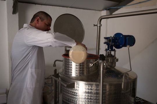 Worker checking quality of gin