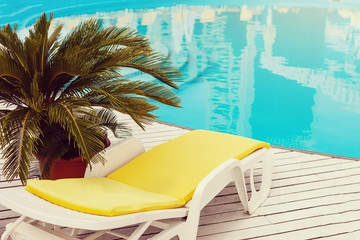 swimming pool with yellows sun lounger