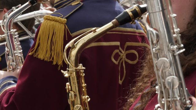 Close up of anonymous female saxophone player in a marching band