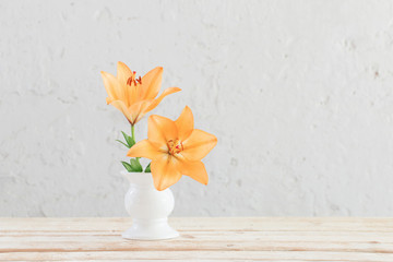 lily in vase on background white wall