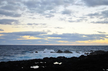 Reunion island seascape, landscape. Black sand, volcanic rocks.