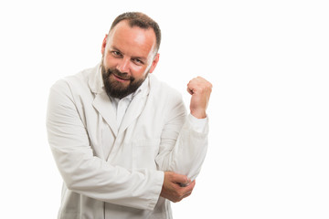 Portrait of male doctor showing elbow pain gesture