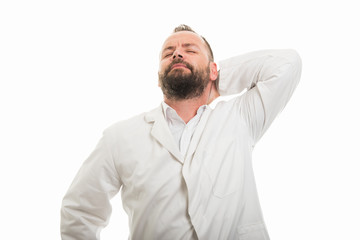 Portrait of male doctor showing back neck pain gesture