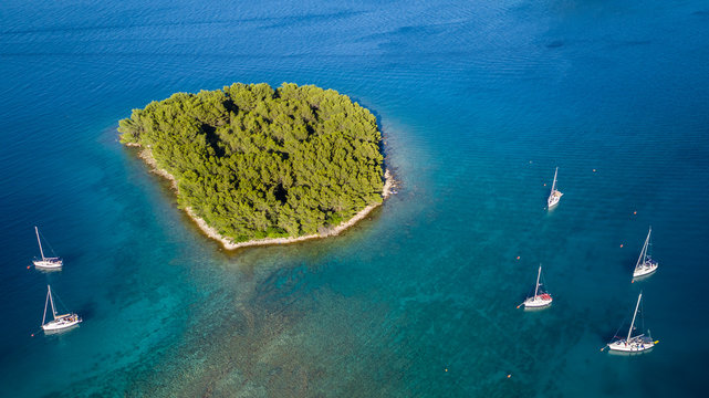 Aerial view of sailing boats anchoring next to small island