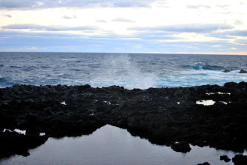 Reunion island seascape, landscape. Black sand, volcanic rocks.