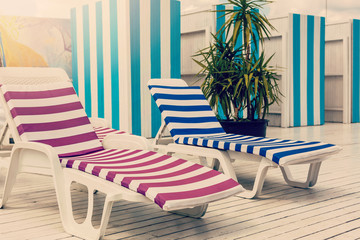 Blue deck chairs at the swimming pool