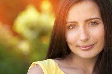 Beautiful woman on field under sunset light