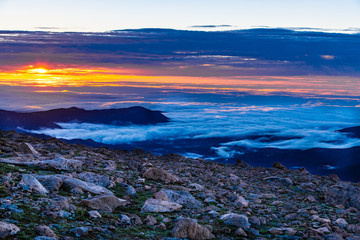 A Cold Rocky Mountain Sunrise Above the Clouds