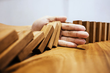 Risk and strategy wealth plan - man hand with wooden block thinking about value investment