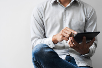 business man using digital tablet with with wall background