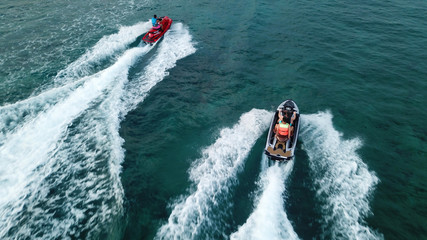 Aerial drone photo of Jet ski cruising in tropical waters