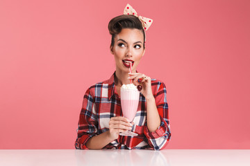 Portrait of a smiling brunette pin-up girl in plaid shirt