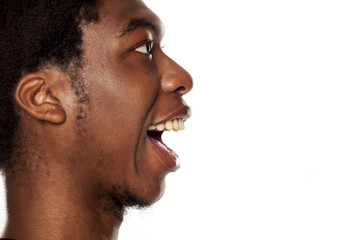 Obraz premium Profile of young happy black african american guy on white background