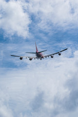Fototapeta na wymiar Airliner flying towards in blue sky