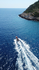 Aerial bird's eye view of inflatable rib boat cruising in high speed in deep blue mediterranean sea