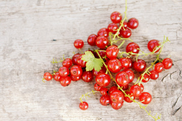 Red currant on wooden background. Summer berry