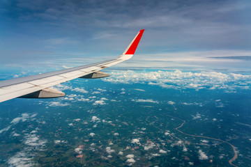 Wing of an airplane sky high cloud view 